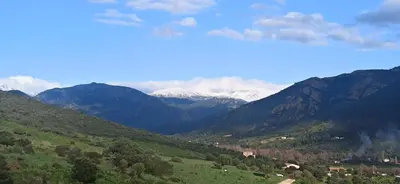 a view of a mountain range with snow covered mountains at Sagone in Vico