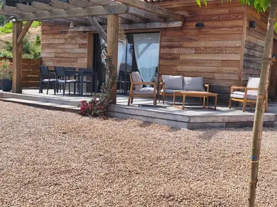 a porch of a cabin with chairs and a table at Sagone in Vico