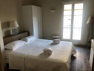 a bedroom with two beds with towels on top of it at Appartement Centre ville in Porto-Vecchio