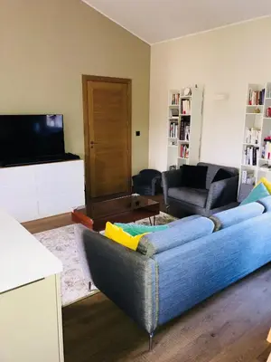 a living room with a blue couch and a tv at Appartement Centre ville in Porto-Vecchio