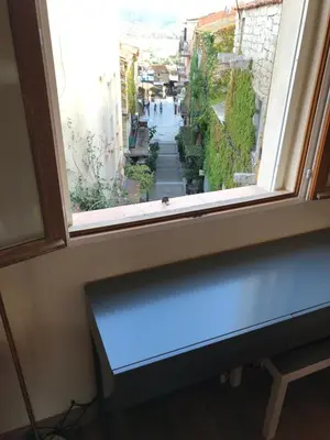 a window with a bench looking out at a street at Appartement Centre ville in Porto-Vecchio