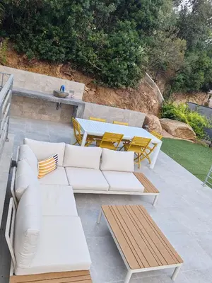 a white couch and tables on a patio at Villa neuve architecte vue mer in Belvédère