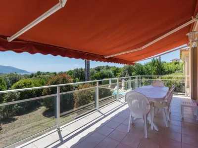 a patio with a table and chairs on a balcony at Spacious Villa with Pool in Santʼ Andrea-dʼOrcino