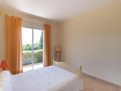 a bedroom with a bed and a large window at Spacious Villa with Pool in Santʼ Andrea-dʼOrcino