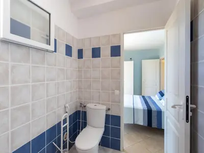 a bathroom with a toilet and a bedroom at Spacious Villa with Pool in Santʼ Andrea-dʼOrcino
