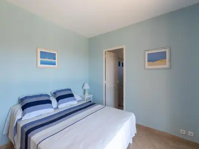 a bedroom with a large bed with blue walls at Spacious Villa with Pool in Santʼ Andrea-dʼOrcino