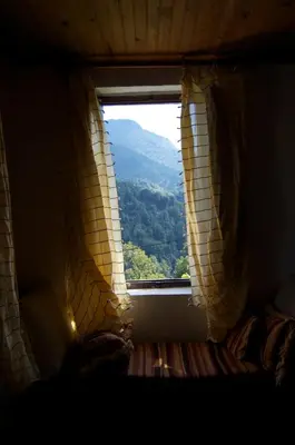 a window in a room with a view of a mountain at Maison de charme Corse sauvage in Pietra-di-Verde