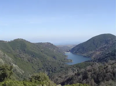 a view of a lake in the middle of mountains at Maison de charme Corse sauvage in Pietra-di-Verde