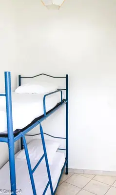 two bunk beds in a room with a wall at Résidence de Filitosa - Le Torréen in Sollacaro