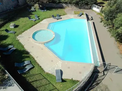 an overhead view of a large swimming pool with chairs around it at Résidence de Filitosa - Le Torréen in Sollacaro