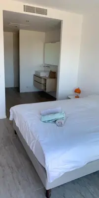 a white bed with two towels on top of it at Villas Pure Mare Bonifacio in Bonifacio