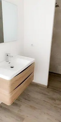 a bathroom with a white sink and a mirror at Villas Pure Mare Bonifacio in Bonifacio