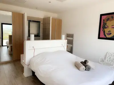 a bedroom with a white bed with two towels on it at Villas Pure Mare Bonifacio in Bonifacio