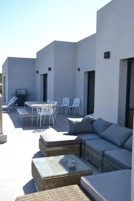 a living room with a couch and a table and chairs at Villas Pure Mare Bonifacio in Bonifacio