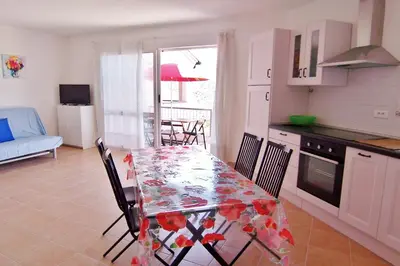 a kitchen and dining room with a table and chairs at MORA in Conca