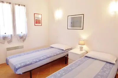 two beds in a room with two windows at MORA in Conca