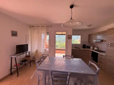 a kitchen with a table and chairs in a kitchen at BIJOU in Conca
