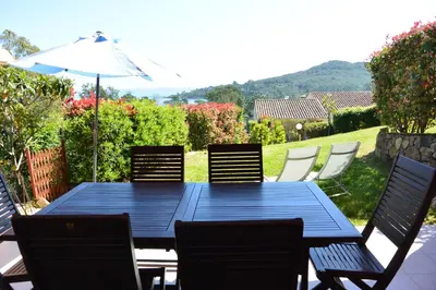 a blue table with chairs and an umbrella at ORO 53 in Conca