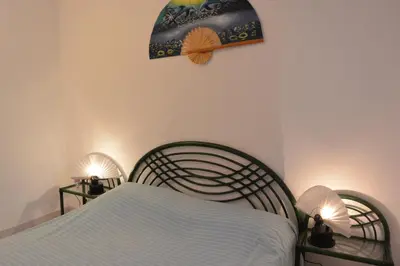 a bedroom with a bed with two lights on it at ORO 53 in Conca