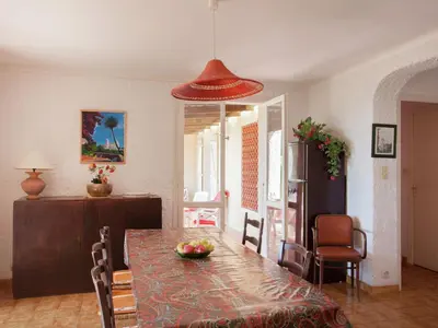 a dining room with a table with a bowl of fruit on it at Cosy Holiday Home in Cargèse Corse-du-Sud near Sea in Cargèse