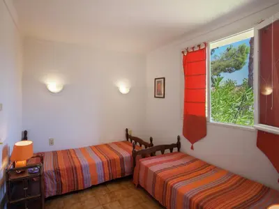 a bedroom with two beds and a window at Cosy Holiday Home in Cargèse Corse-du-Sud near Sea in Cargèse