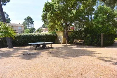 a picnic table and a bench in a park at St CYPRIEN C20 in San Ciprianu