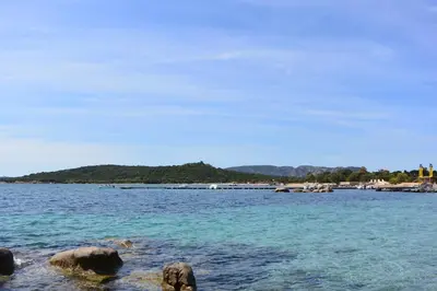 a large body of water with rocks in the water at St CYPRIEN C20 in San Ciprianu