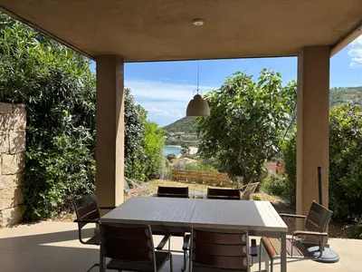 a table and chairs on a patio with a view at ELENA in Conca
