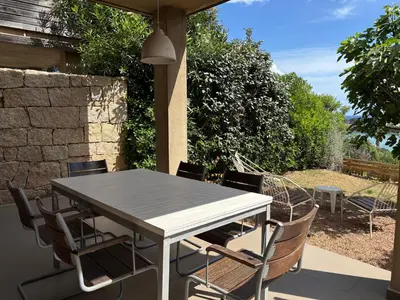 a dining table and chairs on a patio at ELENA in Conca