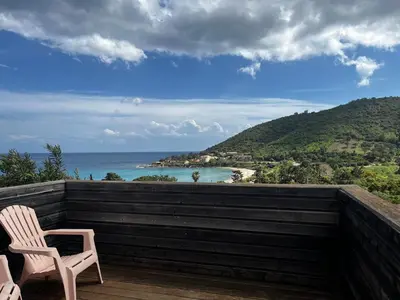 two chairs on a deck with a view of the ocean at ELENA in Conca