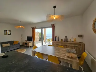 a living room with a large wooden table and chairs at SERENA-Piscine privée- Vue Mer in Conca