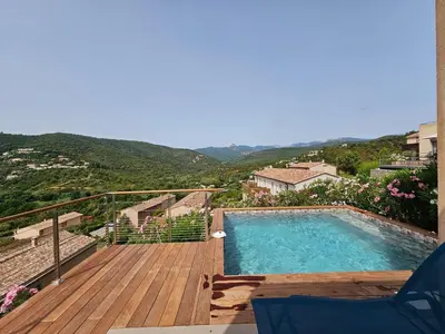 a swimming pool on a wooden deck with a view at SERENA-Piscine privée- Vue Mer in Conca