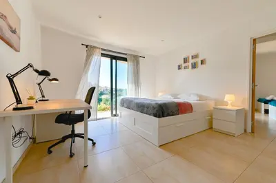 a bedroom with a bed and a desk and a desk at Villa à l'entrée de Porticcio - Piscine - Vue dégagée in Cauro