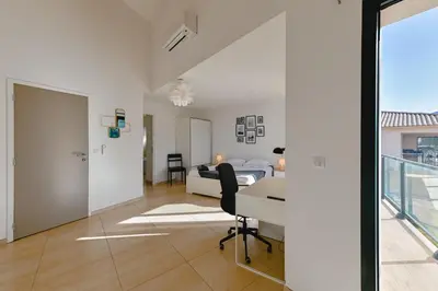 a bedroom with a bed and a desk in a room at Villa à l'entrée de Porticcio - Piscine - Vue dégagée in Cauro