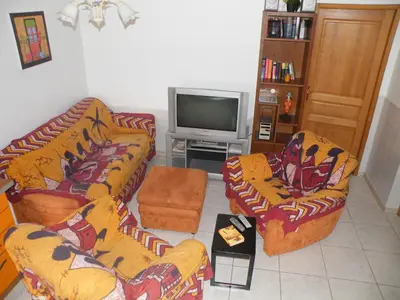 a living room with two couches and a tv at Villa Liamone in Sagone