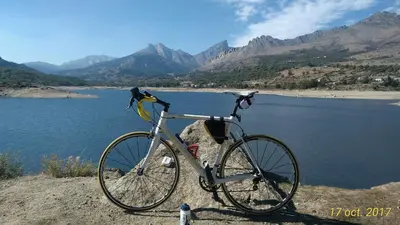a bike parked on a rock next to a body of water at Villa Liamone in Sagone