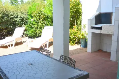a patio with a table and chairs and a fireplace at St CYPRIEN D23 in Porto-Vecchio