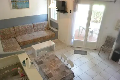 a living room with a couch and a table at St CYPRIEN D23 in Porto-Vecchio