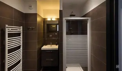 a bathroom with a toilet and a sink and a shower at Studio standing Piscine vue mer in Porto-Vecchio