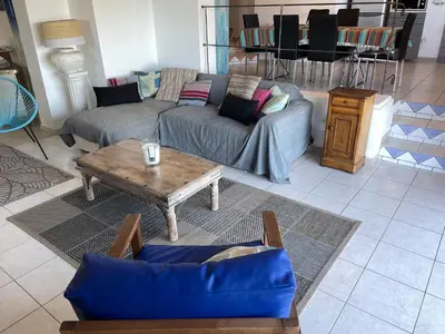 a living room with a couch and a coffee table at Maison & Piscine Privée Vue Mer panoramique très calme indépendant in Porto-Vecchio