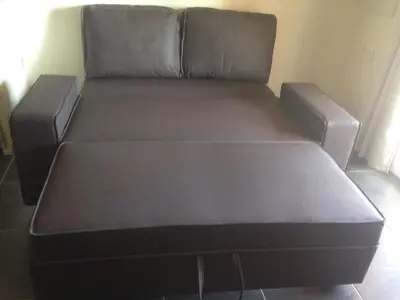 a black couch in a living room at Casapiana 08 in Porto-Vecchio