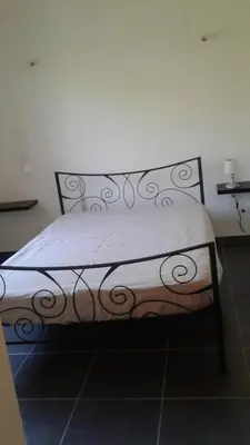 a bedroom with a bed with a white bedspread at Casapiana 08 in Porto-Vecchio