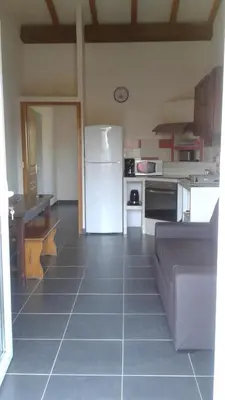 a kitchen with a white refrigerator in a room at Casapiana 08 in Porto-Vecchio