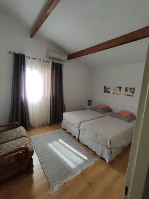 a bedroom with two beds and a window at Villa Jeromine in Porto-Vecchio