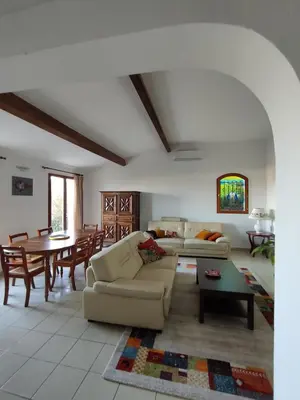 a living room with a couch and a table at Villa Jeromine in Porto-Vecchio
