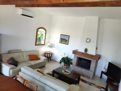a living room with a couch and a fireplace at Villa Jeromine in Porto-Vecchio