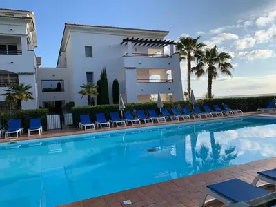 a living room with a couch and a table at Les pieds dans l'eau en Corse ! in Moriani Plage