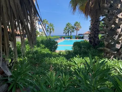 a view of the pool at the resort at Les pieds dans l'eau en Corse ! in Moriani Plage