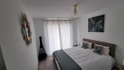 a bedroom with a bed and a window at Résidence Le Bella Vista in Piana