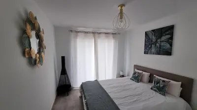 a bedroom with a bed and a window at Résidence Le Bella Vista in Piana